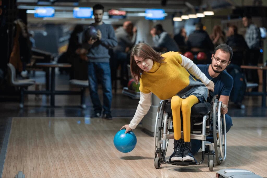 girl in a wheelchair playing bowling