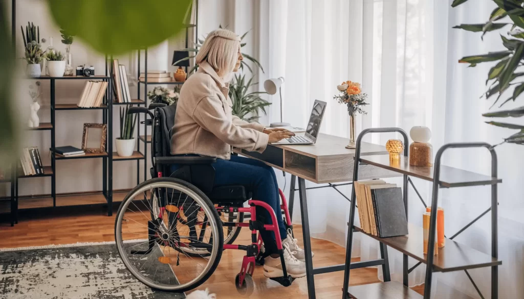 girl in a wheelchair using a laptop